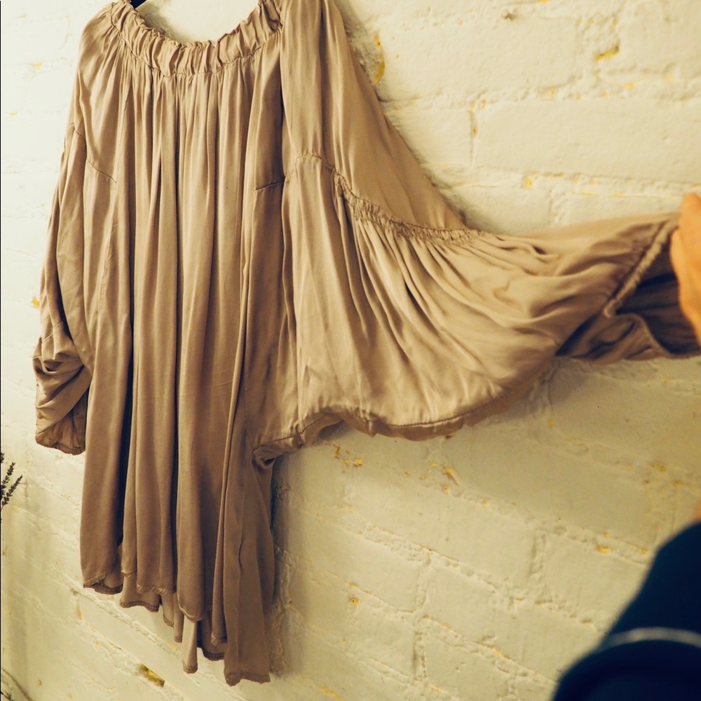 Beautiful ruffled tunic in shimmery tan. Can be worn off the shoulder or on top.